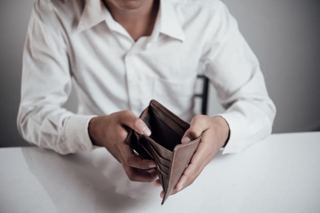 bankruptcy- man showing his wallet with no money